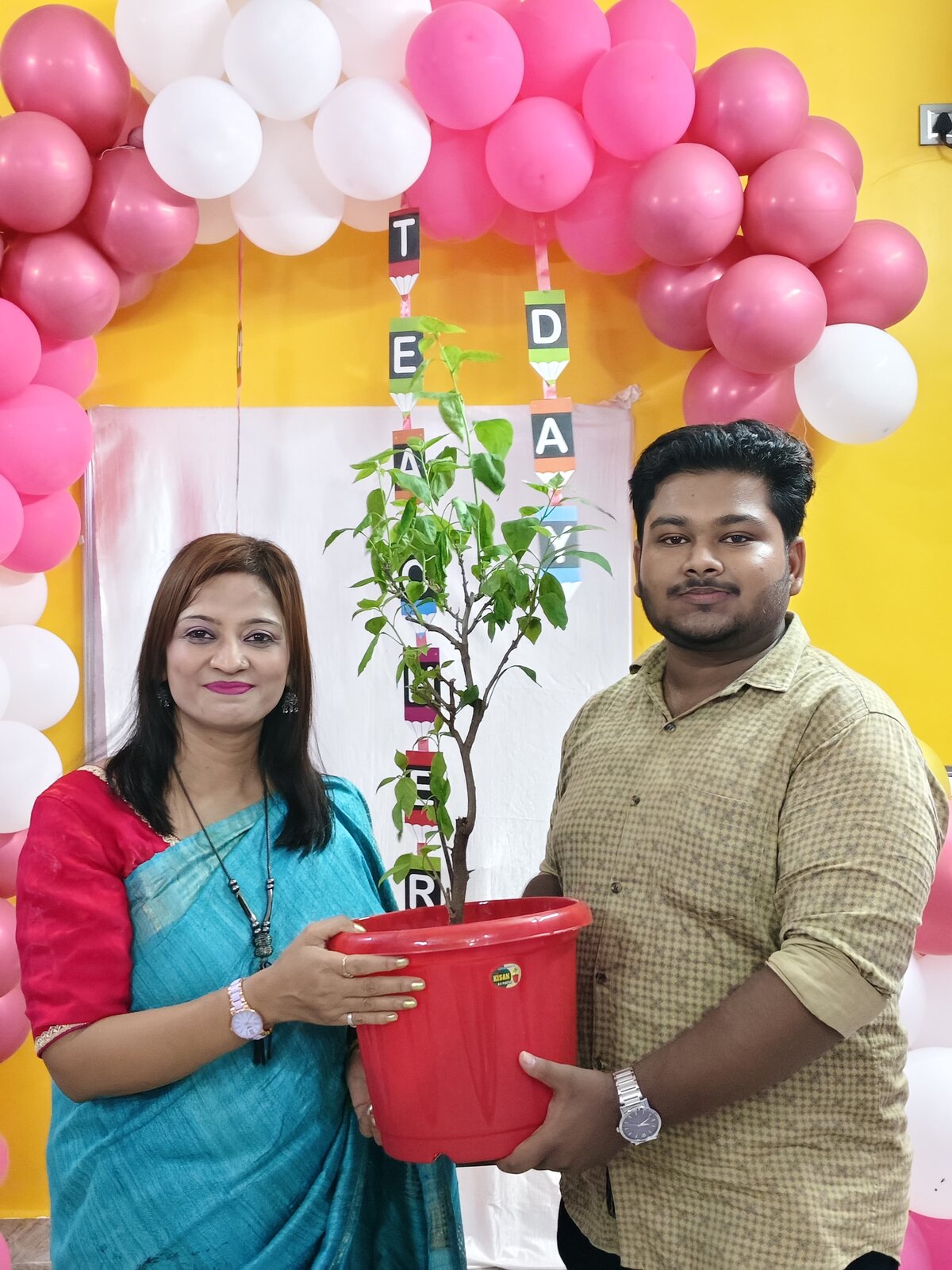 A student gifting Jolly Miss a plant on Teachers Day 2026
