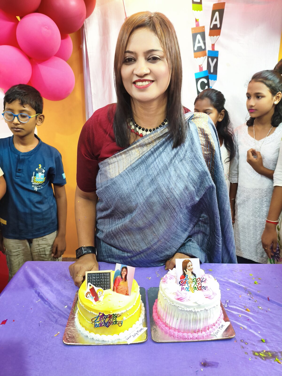 Jolly Miss with this year's Teachers Day cakes, Class 6